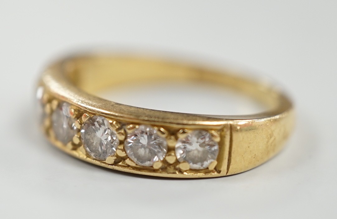 A modern 18ct gold and seven stone diamond set half hoop ring, size P, gross weight 5.3 grams.